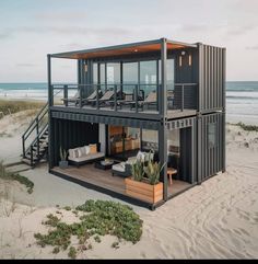 a house made out of shipping containers on the beach