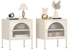 two white side tables with gold accents and a lamp