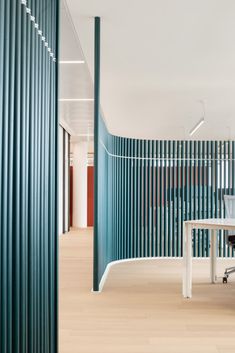 an office with blue and white striped walls