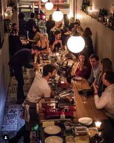 a group of people sitting at a table in a restaurant