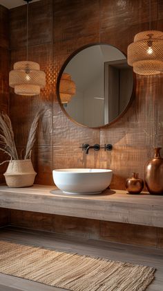 a bathroom with a sink, mirror and vases on the counter in front of it