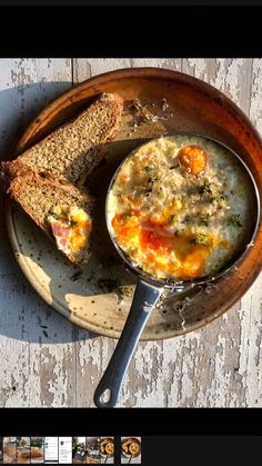 there is a bowl of soup with bread on the side