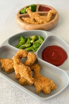 two trays filled with different types of food next to sauce and broccoli