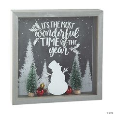 a shadow box with a snowman and christmas trees in the background that says, it's the most wonderful time of the year