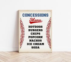 a baseball themed sign is displayed on the floor in front of a white wall and wood floor