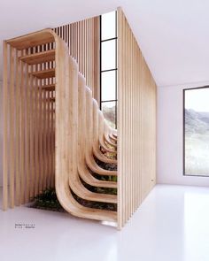 a wooden spiral staircase in an empty room