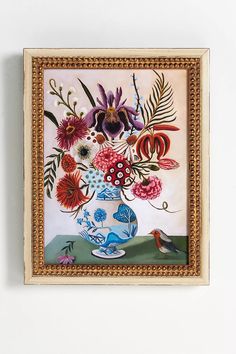 a painting hanging on the wall with flowers and birds in it's vases