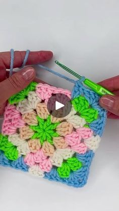 someone is crocheting a granny granny square with yarn and scissors to make it look like an ornament