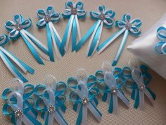 several blue and white bows are arranged in a circle on the floor next to a pillow