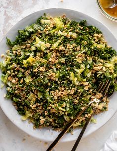 a white plate topped with broccoli and nuts