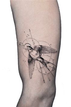 a small bird on the side of a woman's leg with lines and dots