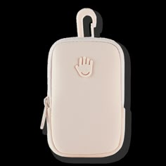 a white case with a small hand on the front and an embellishment in the middle