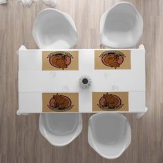 two white urinals with brown stickers on them