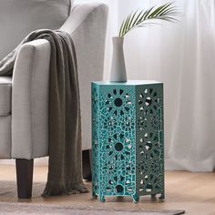 a blue table sitting on top of a wooden floor next to a chair