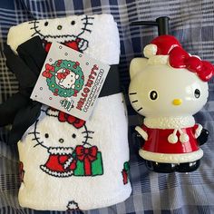 two hello kitty towels are laying next to each other