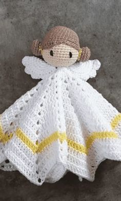 a crocheted doll is laying on the floor