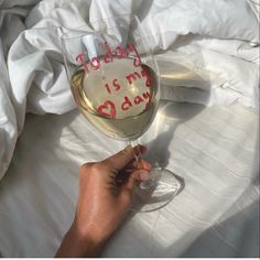 a person holding a wine glass with the words today is my day written on it