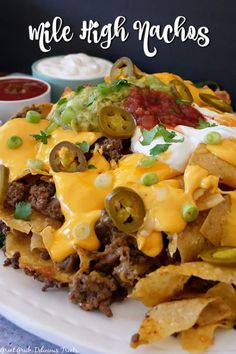 a white plate topped with nachos covered in cheese