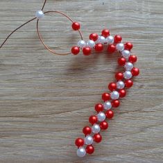 red, white and blue beaded necklace on wooden table with thread spools