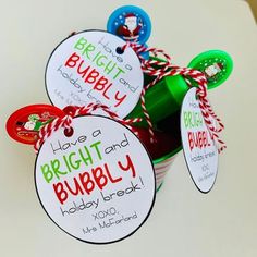 three buckets filled with red and green drinks on top of a white countertop