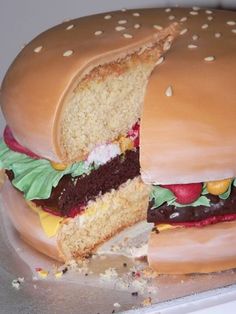 a giant hamburger cake with chocolate frosting and sprinkles on the side