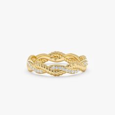 a yellow gold ring with white diamonds on the sides and a twisted design in the middle