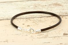 3mm GREEK LEATHER BRACELET WITH STERLING SILVER ENDS AND CARABINER CLASP Dark Brown Handmade by Carla Marie Jewellery using genuine very high-quality 3mm round Greek leather cord. This understated leather cord bracelet will prove to be an elegant addition to any look. The leather will age with wear giving it a more vintage feel. Bracelet is finished with quality sterling silver ends and a sturdy sterling silver carabiner clasp. Bracelet will take charm beads with a hole size of 3.5mm and over. B Pandora Brown Leather Bracelet, Troll Beads, Leather Cord Bracelets, Leather Jewellery, Genuine Leather Bracelet, Bracelet Pandora, Clasp Bracelet, Charms Bracelet, Pandora Bracelet Charms