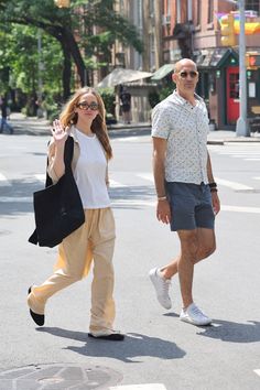 a man and woman walking down the street