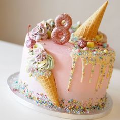 a pink cake with ice cream and sprinkles on top that says 8