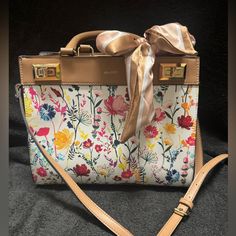 Nwot Aldo Floral Shoulder Or Crossbody Bag. This Bag Is A Beautiful Floral Print With A Bow That Ties On The Handles. It Also Comes With A Strap So You Can Carry It On Your Shoulder Or As A Crossbody Bag. The Strap Is Adjustable. The Hardware Is Gold. I Have Included Pictures With The Measurements. It Has Three Pockets Inside, One Zips & A Compartment On The Outside That Zips. This Bag Has Never Been Used!!! Multicolor Crossbody Satchel With Top Carry Handle, Multicolor Crossbody Satchel With Top Handle, Yellow Tote Bags For Day Out, Yellow Tote Bag For Day Out, Multicolor Spring Satchel Bag, Yellow Crossbody Box Bag With Adjustable Strap, Multicolor Satchel For Spring Shopping, Multicolor Spring Satchel For Shopping, Spring Multicolor Satchel For Shopping