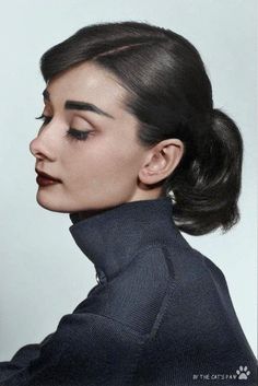 a black and white photo of a woman with her hair in a high pony tail