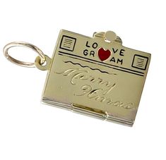 Lovely Christmas charm: a figural "telegram." 14K yellow gold, with a red enamel heart and black enamel lettering on the top of the "LOVEGRAM." "MERRY XMAS" engraved in center. Opens to reveal 2 blank pages, which can be hand-engraved with a personal message. 3/4" x 1/2." Alice Kwartler has sold the finest antique gold and diamond jewelry and silver for over forty years. Vintage 14k Stamped Charms As Gift, Vintage 14k Stamped Charms For Gift, Valentine's Day Gift Charms In Yellow Gold, 14k Gold Charms For Valentine's Day Gift, Gold Engraved Charms For Valentine's Day, Engraved Yellow Gold Charms For Gift, Unusual Rings, Charm School, Gold Charms