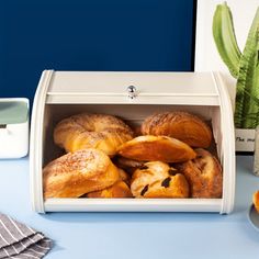 a white box filled with pastries on top of a blue table