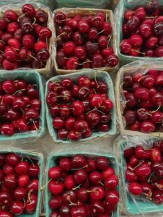 several baskets filled with cherries sitting on top of each other