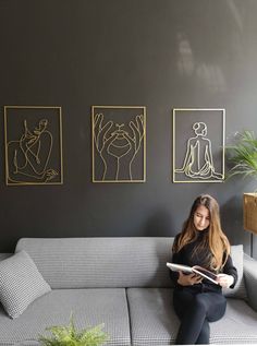 a woman sitting on a couch reading a book