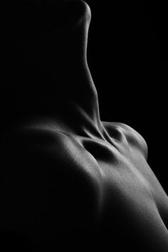 the back of a nude woman in black and white