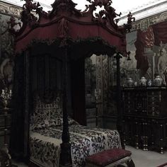 a bedroom with a canopy bed and ornate wallpaper