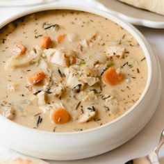 a white bowl filled with chicken and dumpling soup