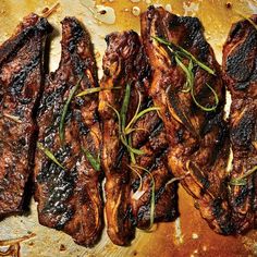 grilled ribs with herbs and seasoning on a baking sheet, ready to be eaten