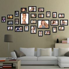 a living room filled with white furniture and pictures on the wall