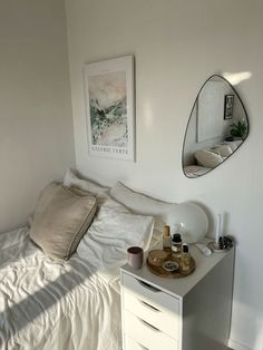 a bedroom with a bed, mirror and other items on the table in front of it