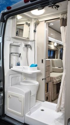 the interior of an rv with a sink, toilet and shower