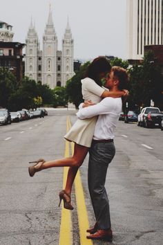 a man and woman kissing on the street