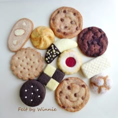 several different types of cookies and pastries on a white surface with the words felt by winnie written above them