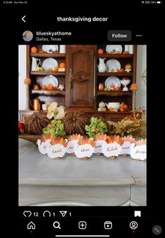 a table topped with lots of pumpkins and other decorations on it's side