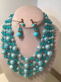 "This is a Mid Century, 4 Strand Turquoise and Green Vintage 1950s Beads and Earrings Set.   These Plastic Beads Sparkle like Glass and are just Beautiful when the light shines on them.  The Necklace measures from 14\" - 19\" with a 4\" Extender.  The Earrings are 1 1/2\" long.  The Fittings are Goldtone.  This Set is in Great Condition and shows very little signs of wear.   As these are a Vintage Set, No Guarantees can be made.  I describe my items as best I can and take my own photos.  If you Mid Century Costume Jewelry, 1950s Beaded Jewelry, Vintage Turquoise Jewelry With Colorful Beads, Retro Jewelry With Faceted Beads, Retro Colorful Beads Jewelry For Jewelry Making, Retro Beaded Round Jewelry, Retro Colorful Beads Jewelry For Making, Retro Beaded Jewelry With Round Beads, Retro Round Beaded Jewelry