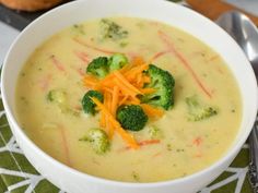 a white bowl filled with broccoli cheese soup