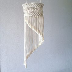 a white macrame hanging from the ceiling