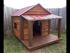 a dog house made out of wood with a metal roof