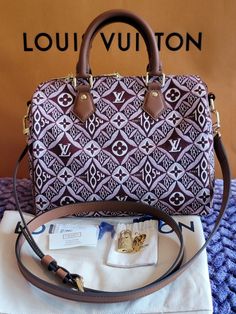 Brand New Condition Louis Vuitton 1854 Speedy 25 Burgundy Jacquard Bag Giant Monogram Limited Edition. Comes with Box, Dust Bag, Tags.  Condition is New with tags. The classic Speedy Bandoulière 25 handbag looks striking in Jacquard Since 1854 textile with gold-color hardware and black leather trim. The new woven pattern, introduced by Nicolas Ghesquière Collection, combines Monogram Blossoms with other House symbols and the number 1854, the year of Louis Vuitton started his business. 9.8 x 7.5 Speedy Bandoulière 25, Speedy Bandouliere 25, Speedy 25, Woven Pattern, Bag Tags, Leather Trim, Leather Trims, Gold Color, Dust Bag